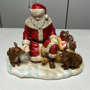 Resin Santa with bag of toys , and reindeer’s